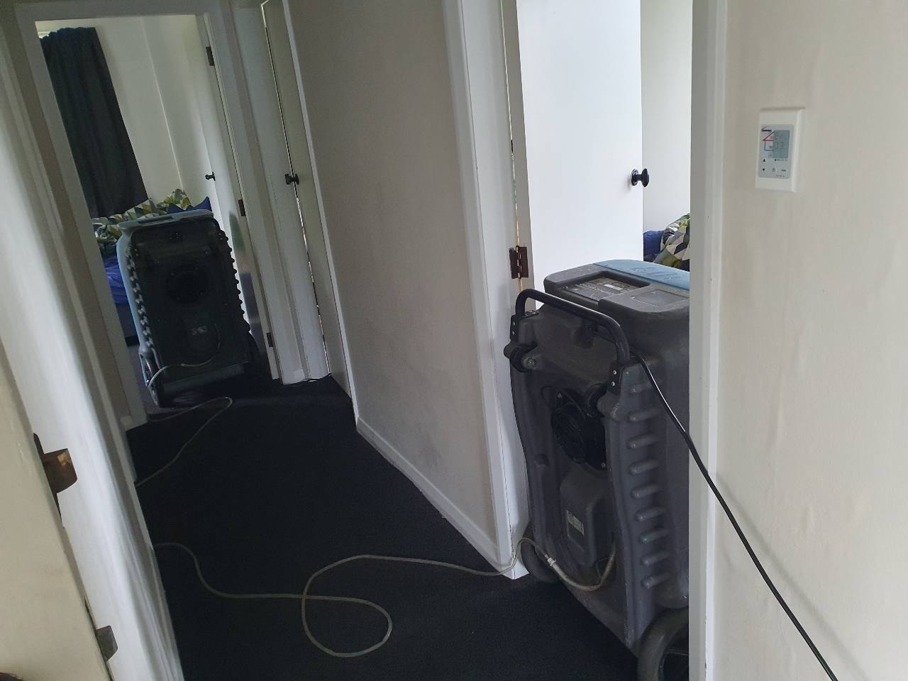 Flood restoration drying equipment in a hallway